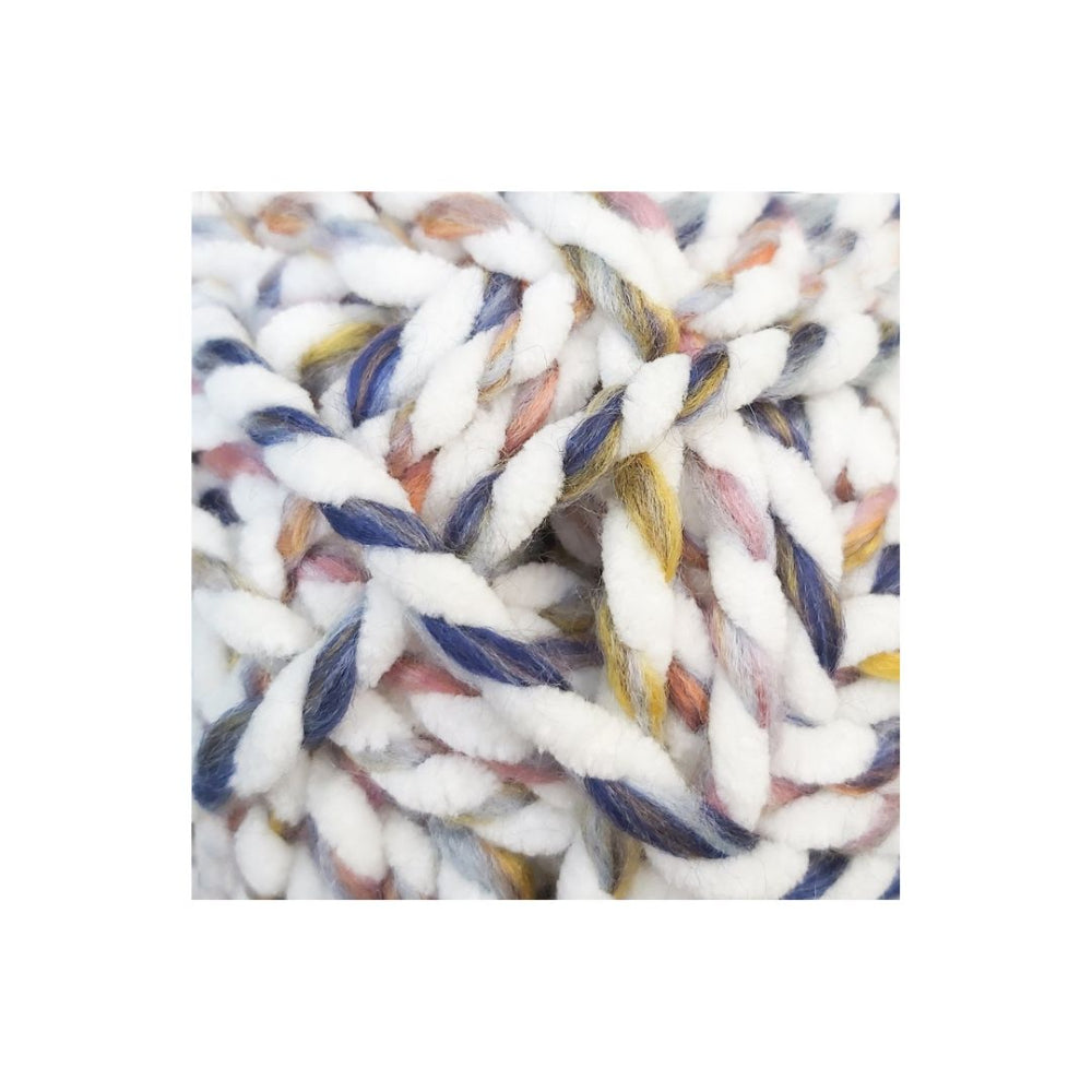 A close-up of chunky twisted yarn with a variegated colour pattern of white, navy blue, dusty pink, and yellow.