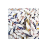 A close-up of chunky twisted yarn with a variegated colour pattern of white, navy blue, dusty pink, and yellow.