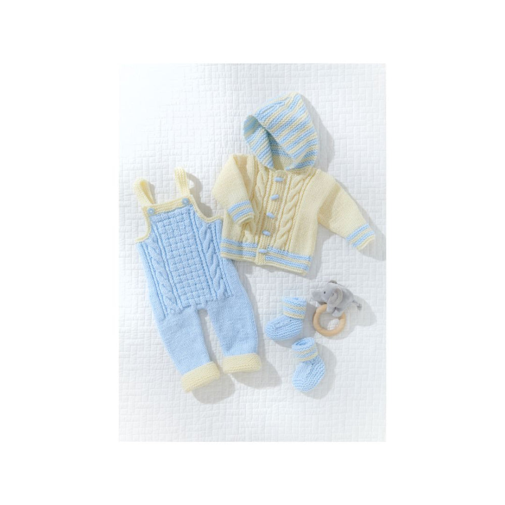 A baby knit clothing set laid flat on a white textured background, including a pale yellow hooded cardigan with light blue trim, a light blue cable-knit romper with pale yellow trim, matching booties, and a small gray teething ring.
