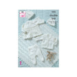 King Cole double knit baby clothing pattern cover showing white knitted baby garments including a cardigan, hat, booties, and a shawl arranged on a pale blue background.