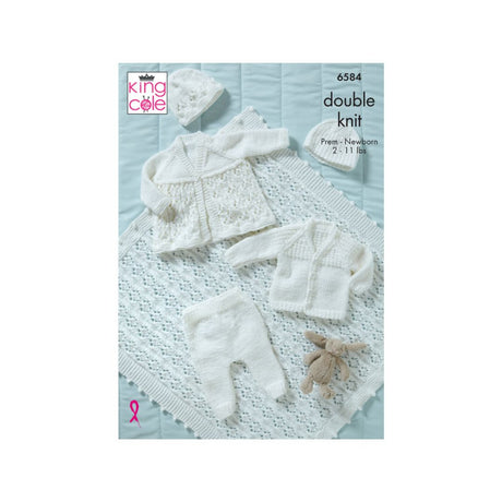 King Cole double knit baby clothing pattern cover showing white knitted baby garments including a cardigan, hat, booties, and a shawl arranged on a pale blue background.