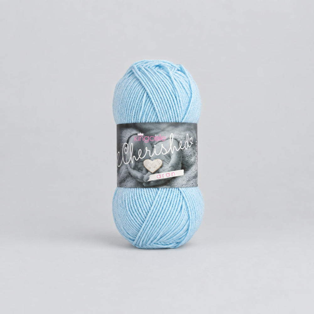 A skein of light blue yarn with a dark gray paper label, centered on a plain white background.