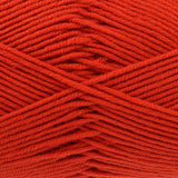 A close-up of bright red yarn strands wound together, showing the texture and colour of the fibre.