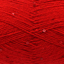 A close-up of bright red yarn with small sequins woven throughout, filling the entire frame.