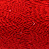 A close-up of bright red yarn with small sequins woven throughout, filling the entire frame.
