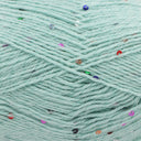 Close-up of mint green yarn with scattered small multicoloured sequins 