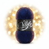 A skein of King Cole Dazzle DK yarn in a deep navy blue colour with subtle sequins throughout, wrapped in a black label with silver and white lettering.