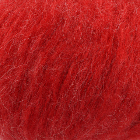 A close-up texture shot of bright red mohair yarn, showing the fine, fluffy fibres.