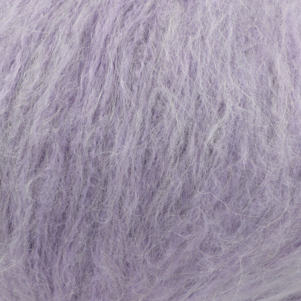 A close-up texture shot of fluffy, shaggy lavender-purple yarn, showing the fine strands and soft, fuzzy surface.