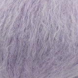A close-up texture shot of fluffy, shaggy lavender-purple yarn, showing the fine strands and soft, fuzzy surface.