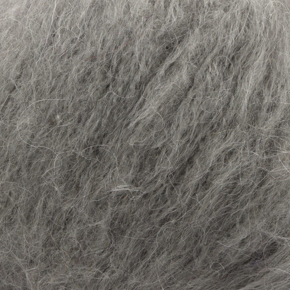 A close-up texture shot of fluffy grey wool, showing the dense, soft fibres.