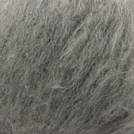 A close-up texture shot of fluffy grey wool, showing the dense, soft fibres.