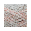 A close-up of fluffy chenille yarn strands in a variegated pattern of white, light grey, and peach-orange, centred on a white background.