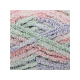 A close-up of fluffy, fuzzy chenille yarn strands in a pastel tie-dye mix of pink, green, purple, and white, arranged in soft horizontal layers.