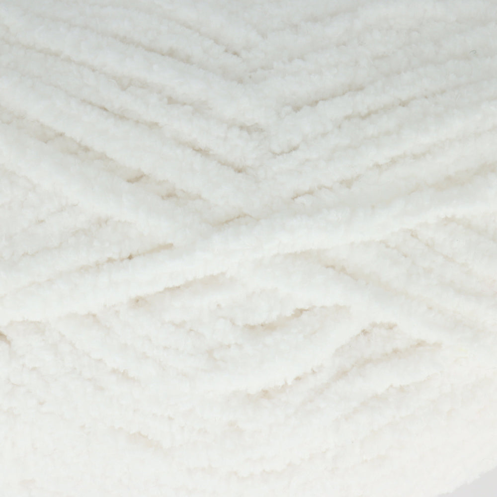 A close-up of fluffy white yarn wound in a textured chevron pattern.