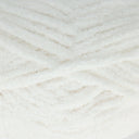 A close-up of fluffy white yarn wound in a textured chevron pattern.