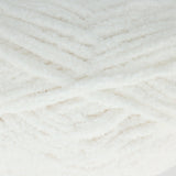 A close-up of fluffy white yarn wound in a textured chevron pattern.