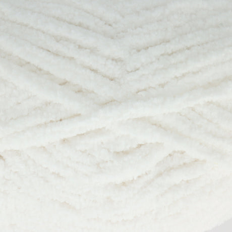 A close-up of fluffy white yarn wound in a textured chevron pattern.