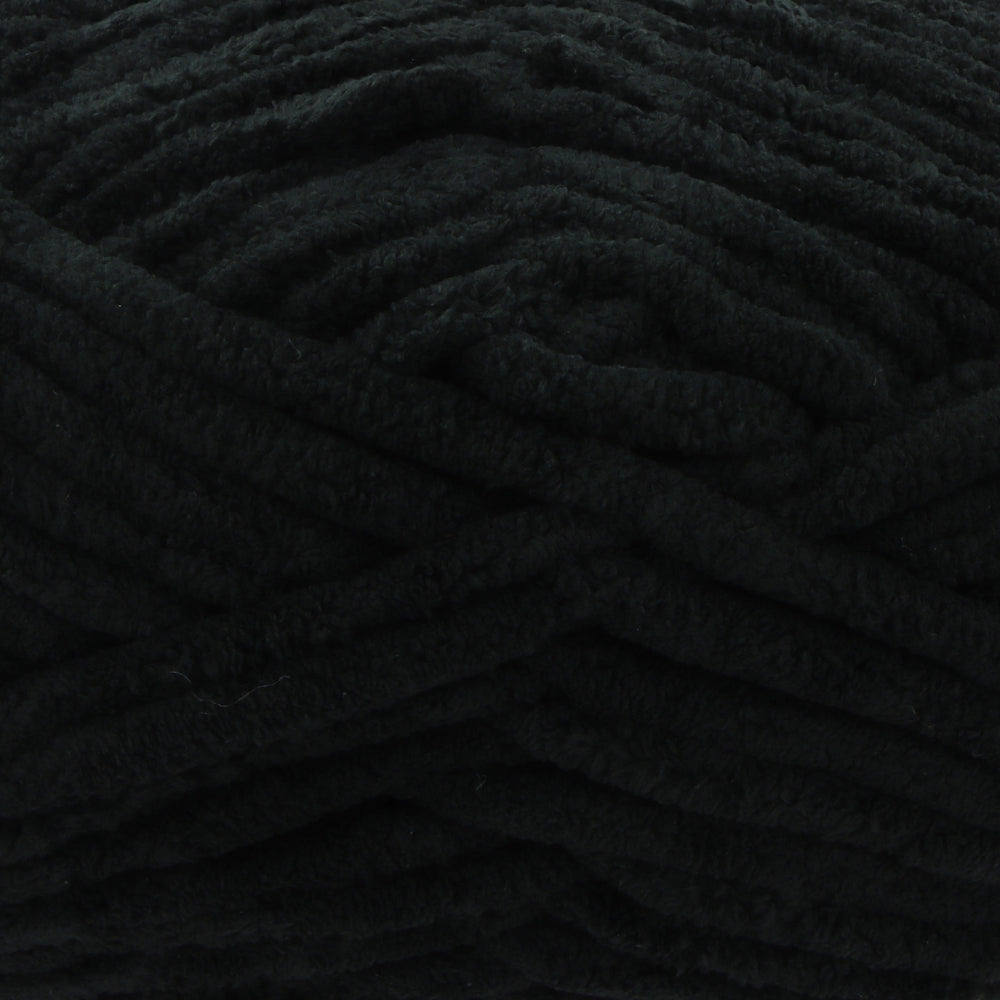 A close-up of thick, plush black yarn with a soft, fuzzy texture filling the entire frame.