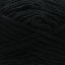 A close-up of thick, plush black yarn with a soft, fuzzy texture filling the entire frame.
