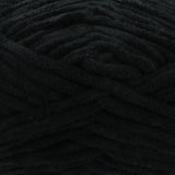 A close-up of thick, plush black yarn with a soft, fuzzy texture filling the entire frame.