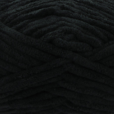 A close-up of thick, plush black yarn with a soft, fuzzy texture filling the entire frame.