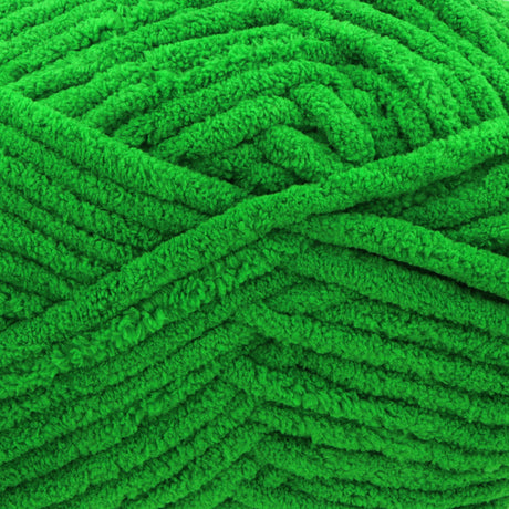 A close-up of bright green plush chenille yarn, showing the thick, fuzzy texture of the strands.