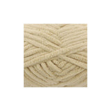 A close-up of thick, plush chenille yarn strands in a warm cream or light beige colour, arranged in a textured spiral pattern on a plain white background.