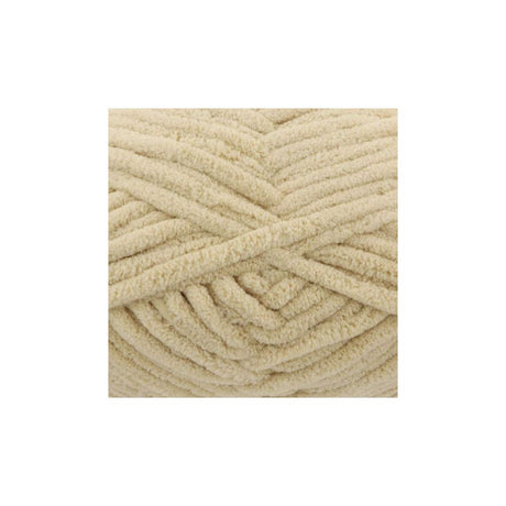A close-up of thick, plush chenille yarn strands in a warm cream or light beige colour, arranged in a textured spiral pattern on a plain white background.