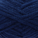 A close-up of thick, plush yarn in a deep navy blue colour, showing the soft, textured surface of the strands.