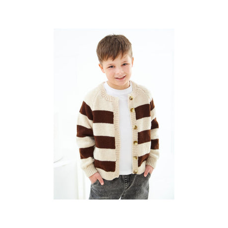 A young boy wearing a brown and cream striped knit cardigan over a white t-shirt and gray jeans, standing against a bright white background.