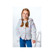 A young girl with braided hair wearing a pastel multicolor knit hooded cardigan with wooden buttons and blue jeans, standing against a white studio background.