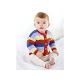 A baby sitting on a white blanket wearing a colourful striped knit cardigan with red, orange, yellow, green, blue, and purple stripes, paired with cream pants.