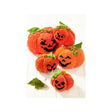Five knitted orange jack-o'-lantern pumpkins with green leaves and black embroidered faces, arranged on a white wood surface.