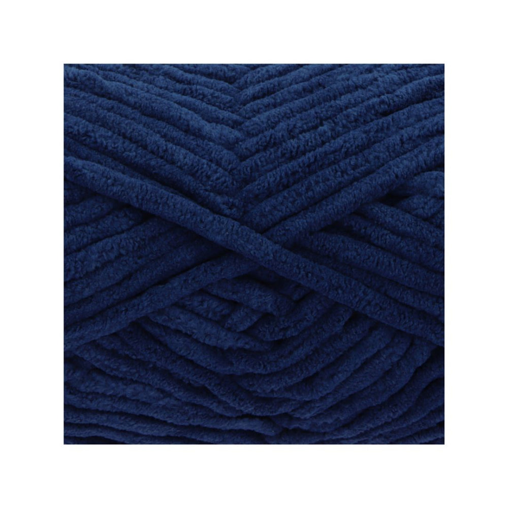 A close-up of thick, plush yarn wound in a crisscross pattern, showcasing its deep navy blue colour and soft, fuzzy texture.