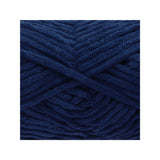 A close-up of thick, plush yarn wound in a crisscross pattern, showcasing its deep navy blue colour and soft, fuzzy texture.