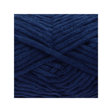 A close-up of thick, plush yarn wound in a crisscross pattern, showcasing its deep navy blue colour and soft, fuzzy texture.