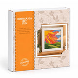Kinusaiga Kit Sun craft kit box by Peek Doko, featuring a white and orange package design with a floral pattern and an illustration of a colourful sun painting.