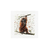 A square art print or canvas featuring a painted brown orangutan hanging from a branch, surrounded by small paint splatters on a white background.