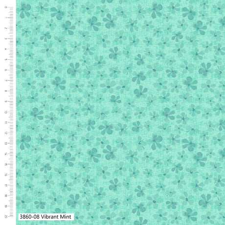 Teal fabric with small floral pattern and ruler for scale