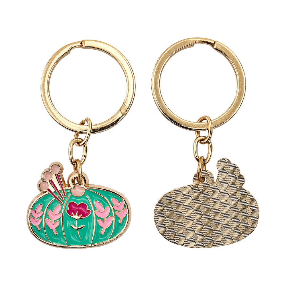 Two keychains with pincushion design on a white background