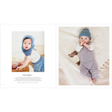 A two-page baby clothing catalog spread showing a baby wearing a knitted blue bonnet and matching knit outfit, with one page featuring a baby crawling and the other a baby lying on a cream blanket.
