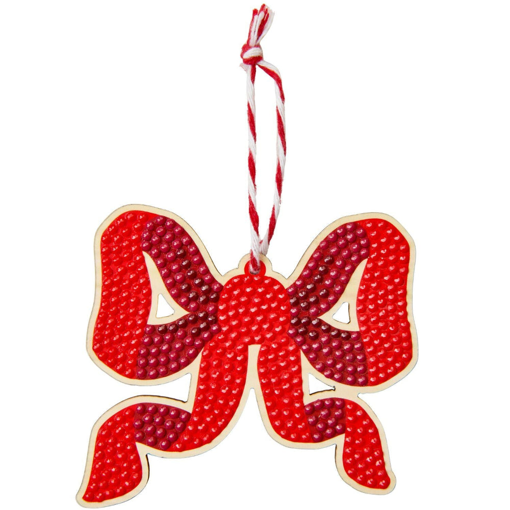 A red and pink bow-shaped Christmas ornament with a textured pattern, featuring a white hanging string at the top, shown against a plain white background.