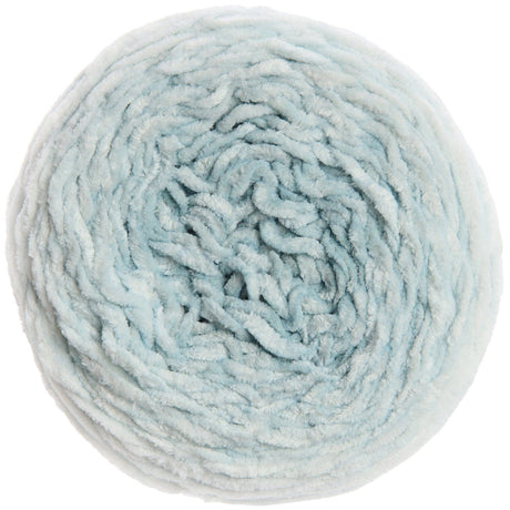 A top-down view of a single ball of fluffy, chunky yarn in a pale icy blue color, isolated on a white background.