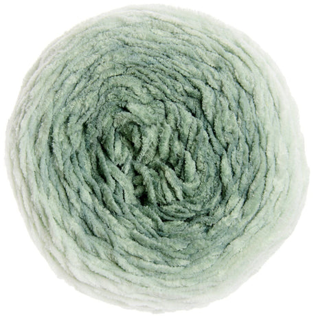 A single ball of soft, fuzzy yarn in a pale sage green color, photographed from directly above on a solid white background.