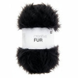 A skein of black faux fur yarn wrapped in a white paper band labeled 'creative FUR' against a plain white background.
