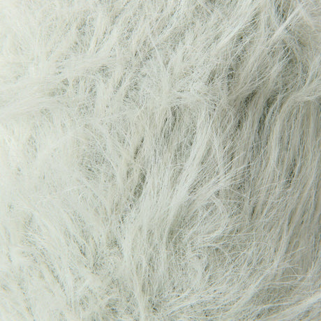A close-up texture shot of fluffy faux fur fabric in a very light off-white color.