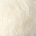 A close-up of fluffy faux fur fabric in a warm off-white or cream color.