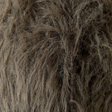 A close-up texture shot of shaggy faux fur fabric in a taupe-brown color, showing individual strands and the soft, fluffy material.