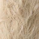 A close-up texture shot of shaggy, long-pile faux fur fabric in a light cream or beige color.